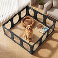 Black framed clear acrylic pet playpen with twelve panels on a wood floor