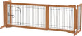 Freestanding wire pet gate with side panels and small walk-through door in a hallway