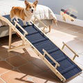 64 inch foldable wooden dog ramp with side rails and non-slip mat leaning against a high bed