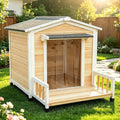 White elevated wooden dog house with front porch and asphalt shingle roof
