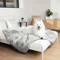 Arctic fox faux fur waterproof throw for dogs and cats on a bed