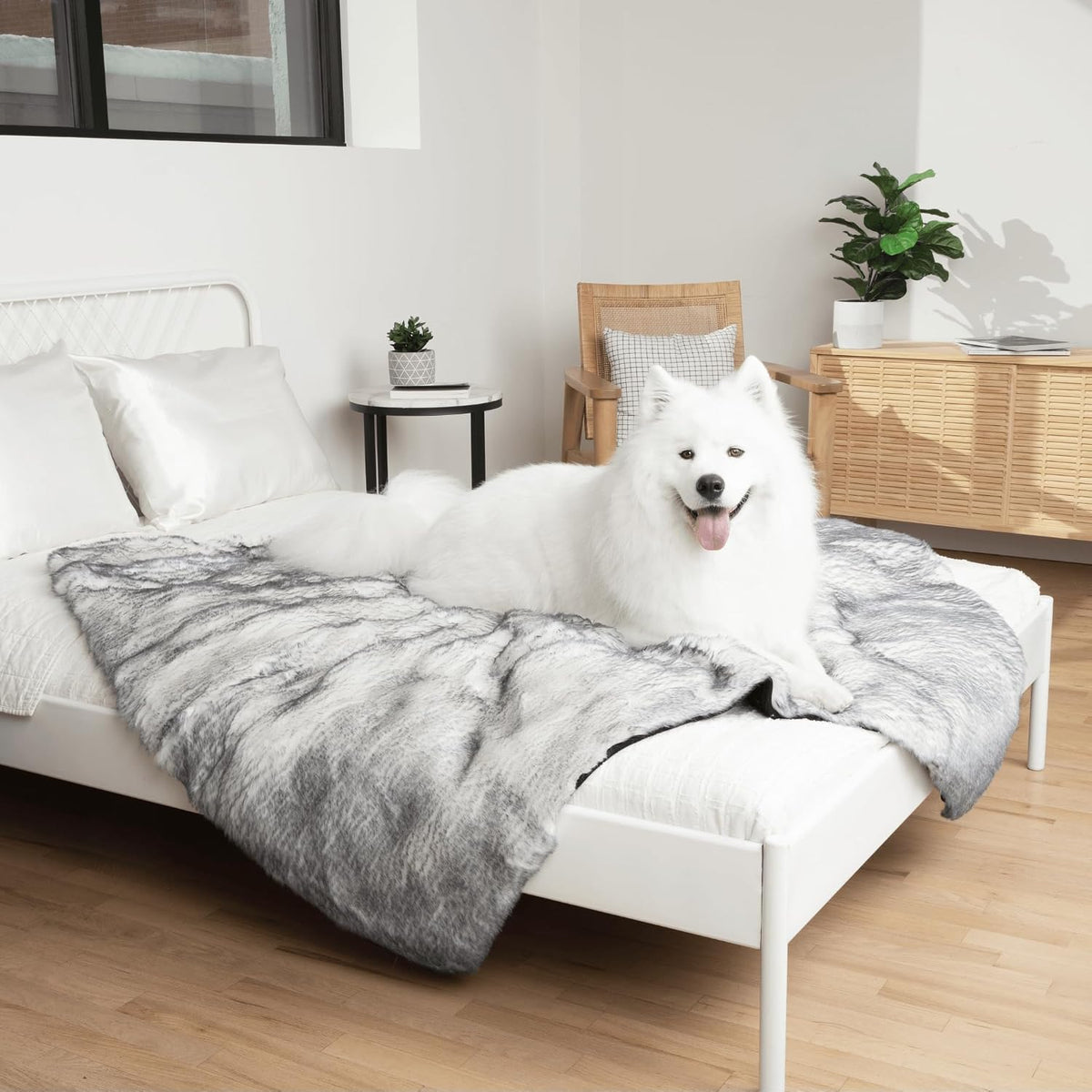 Arctic fox faux fur waterproof throw for dogs and cats on a bed