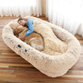 Beige large human dog bed with faux fur cover and pillow