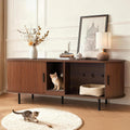 Brown fluted litter box enclosure cabinet with sliding door used as a TV stand