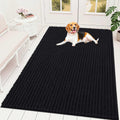Black chenille dog mud mat in a mudroom with paw prints