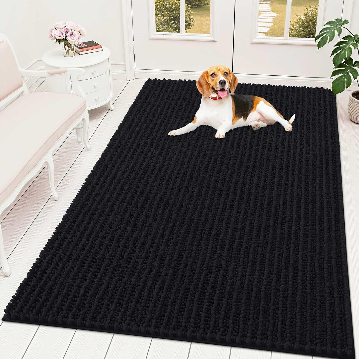 Black chenille dog mud mat in a mudroom with paw prints