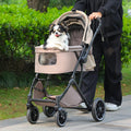 Black folding dog stroller with four wheels, cup holder and storage basket – view 2