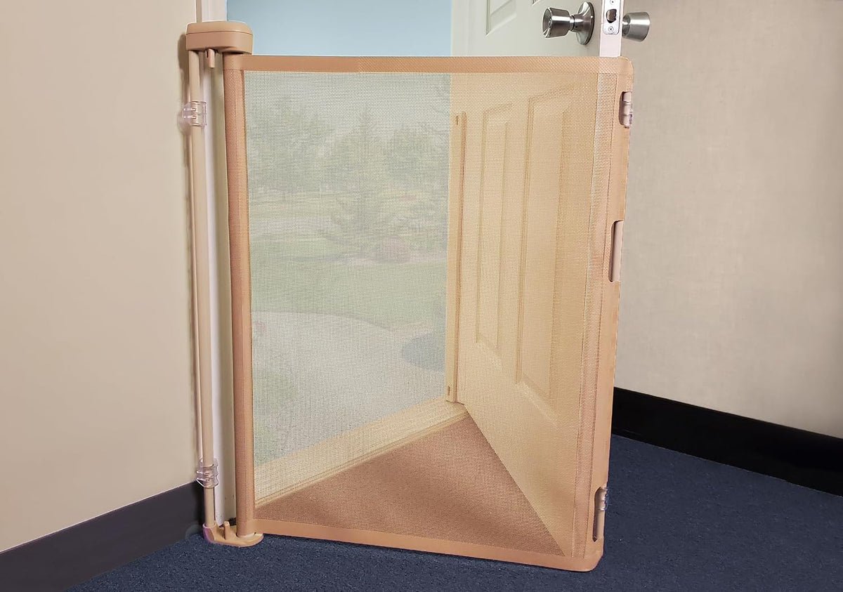White retractable pet barrier mounted inside an exterior door – view 2