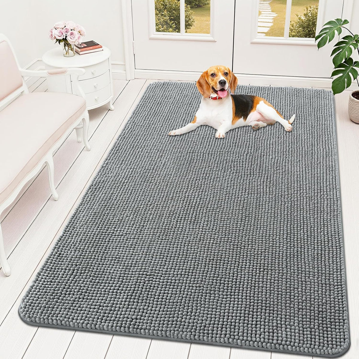 Large grey chenille rug in an entryway with a dog standing on it