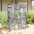 Gray wooden outdoor catio enclosure with mesh walls, platforms and hammock
