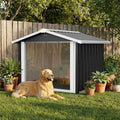 Metal dog house shaped like a garden shed with clear PVC flap door