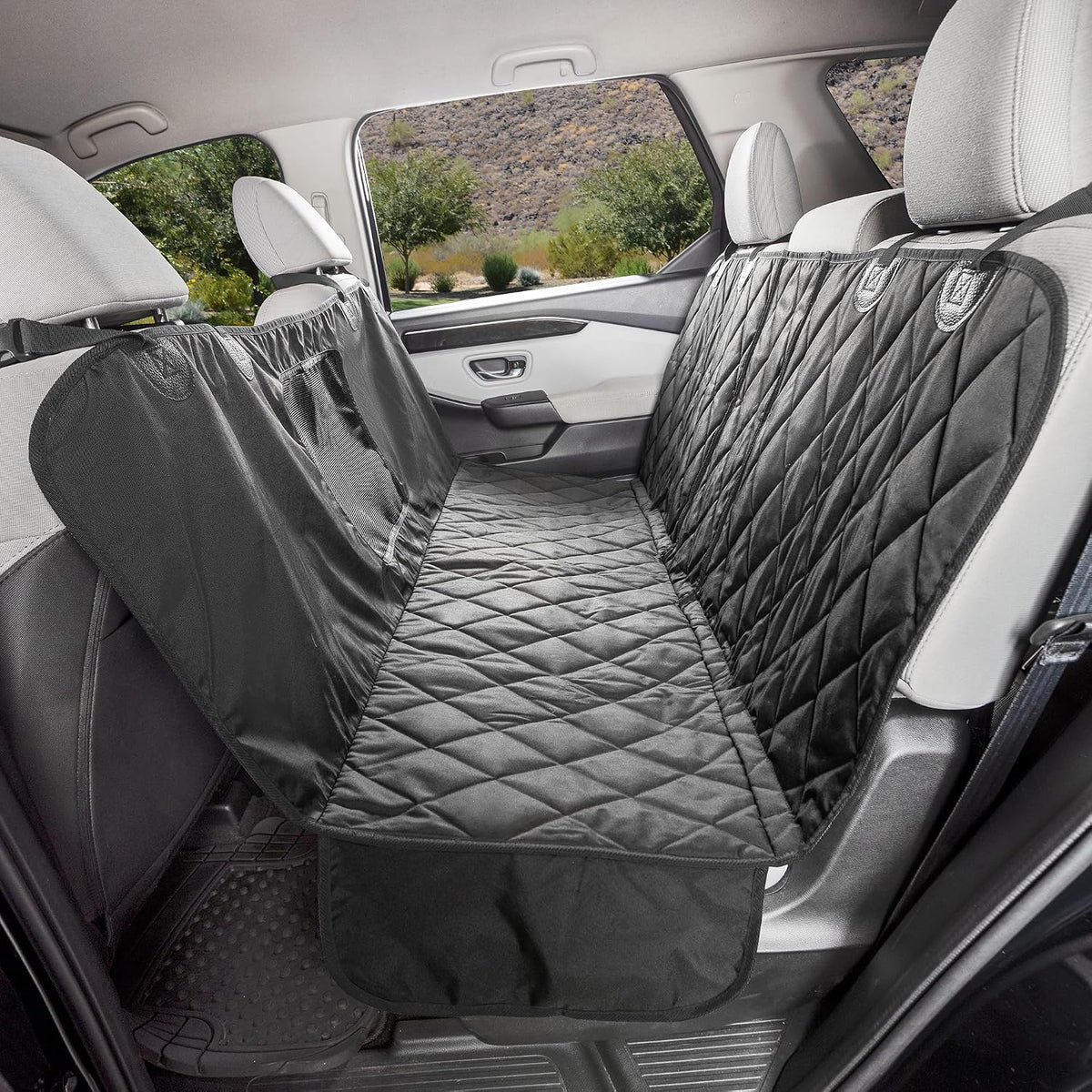 Black split rear seat dog hammock with mesh window in a car