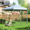 Tall chain link outdoor dog kennel with roof and metal gate in a backyard